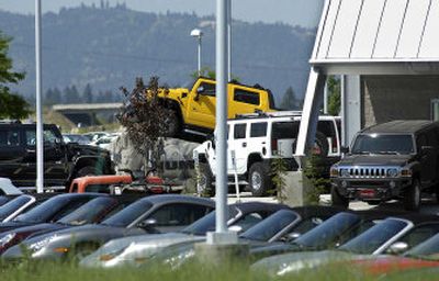 
Hummers and Porsches await buyers at the George Gee Dealership and Porsche of Spokane in Liberty Lake. The Porsche brand has just been added to the George Gee Automotive Group to meet market demand in the area. 
 (Liz Kishimoto / The Spokesman-Review)