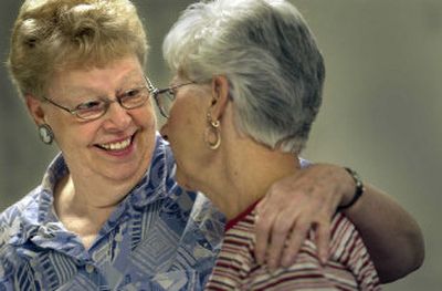 
Laura Schlangen, left, hugs her friend Belva Williams during a Thursday volunteer session at Corbin Senior Center during which the newsletter was stuffed and mailed. 
 (Christopher Anderson/ / The Spokesman-Review)