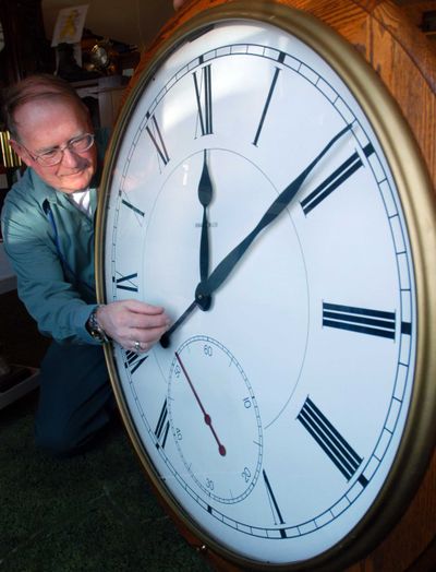 Pat Boyden, owner of the Green Mountain Clock Shop in Williston, Vt., sets the time forward on one of the hundreds of clocks in his shop in preparation for daylight saving time. This year, the time switch will go into effect Sunday. (Associated Press)