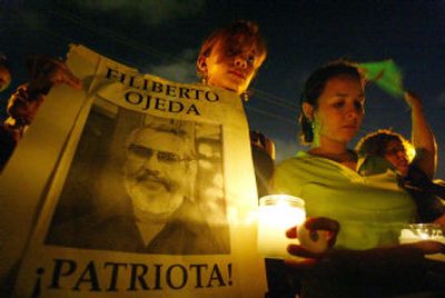 
Supporters of Puerto Rican nationalist leader Filiberto Ojeda Rios take part in a vigil outside the FBI offices in San Juan, Puerto Rico, late Saturday. The FBI shot and killed Ojeda Rios on Friday after he opened fire as they came to arrest him. 
 (Associated Press / The Spokesman-Review)