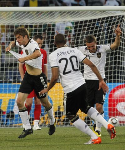 Germany's Thomas Mueller, left, celebrates after scoring the third goal during the World Cup match against England.  (Associated Press)