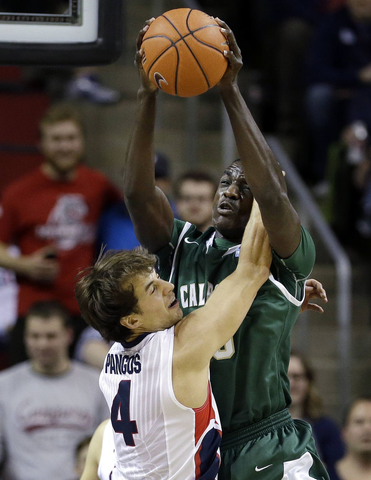 Kevin Pangos collides with Cal Poly’s Joel Awich. (Associated Press)