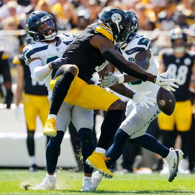 Pittsburgh Steelers wide receiver DK Metcalf can't hold onto a pass as he is hit by Seattle Seahawks safety Julian Love during the second quarter Sunday, Sept. 14, 2025, at Acrisure Stadium in Pittsburgh. (Jennifer Buchanan/Seattle Times)