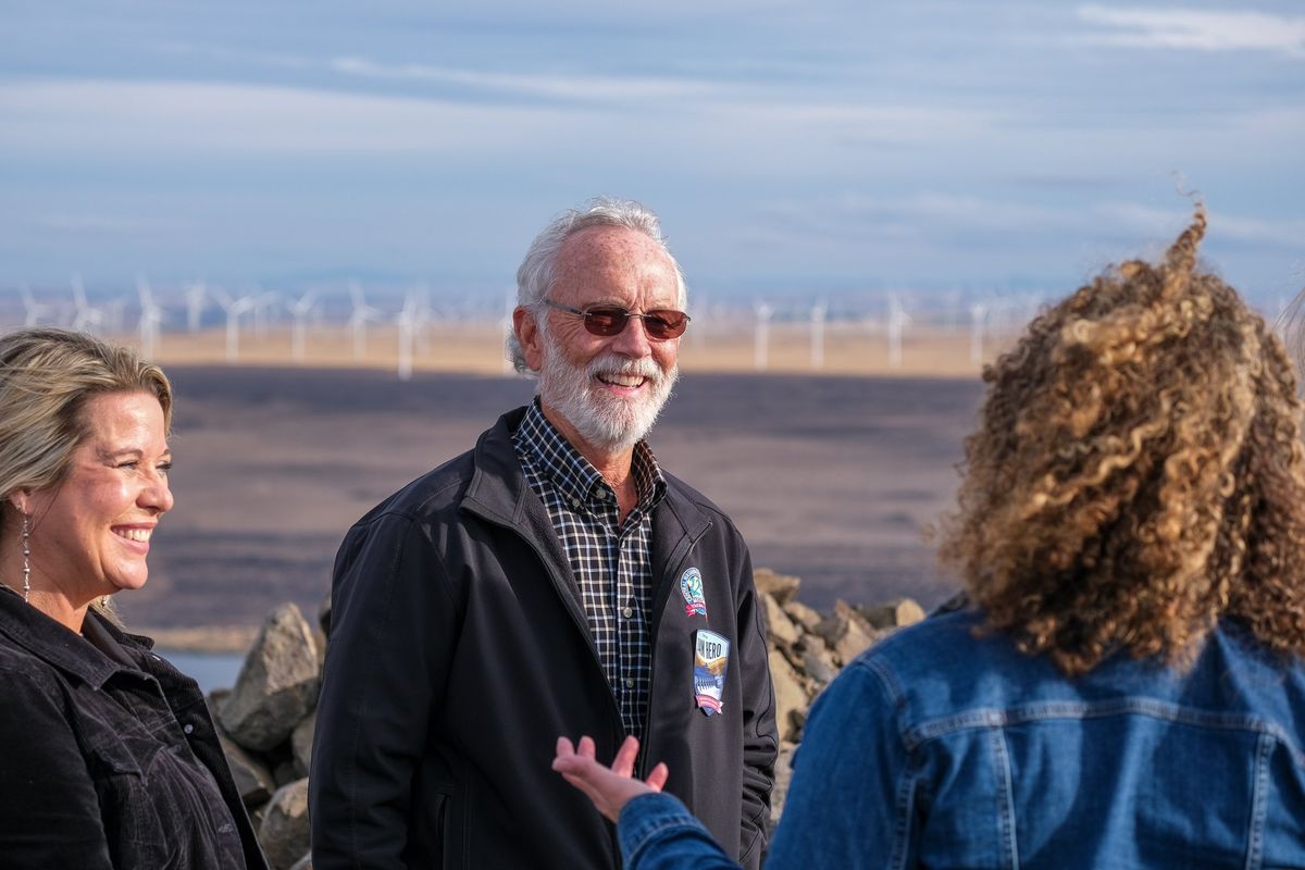 Rep. Dan Newhouse, R-Sunnyside, talks with Michelle Hennings, left, executive director of the Washington Association of Wheat Growers, and Rep. Celeste Maloy, R-Utah, on Oct. 9 at an overlook above the Columbia River near Roosevelt, Wash. Newhouse was re-elected in the Nov. 5 election.  (Orion Donovan Smith/The Spokesman-Review)