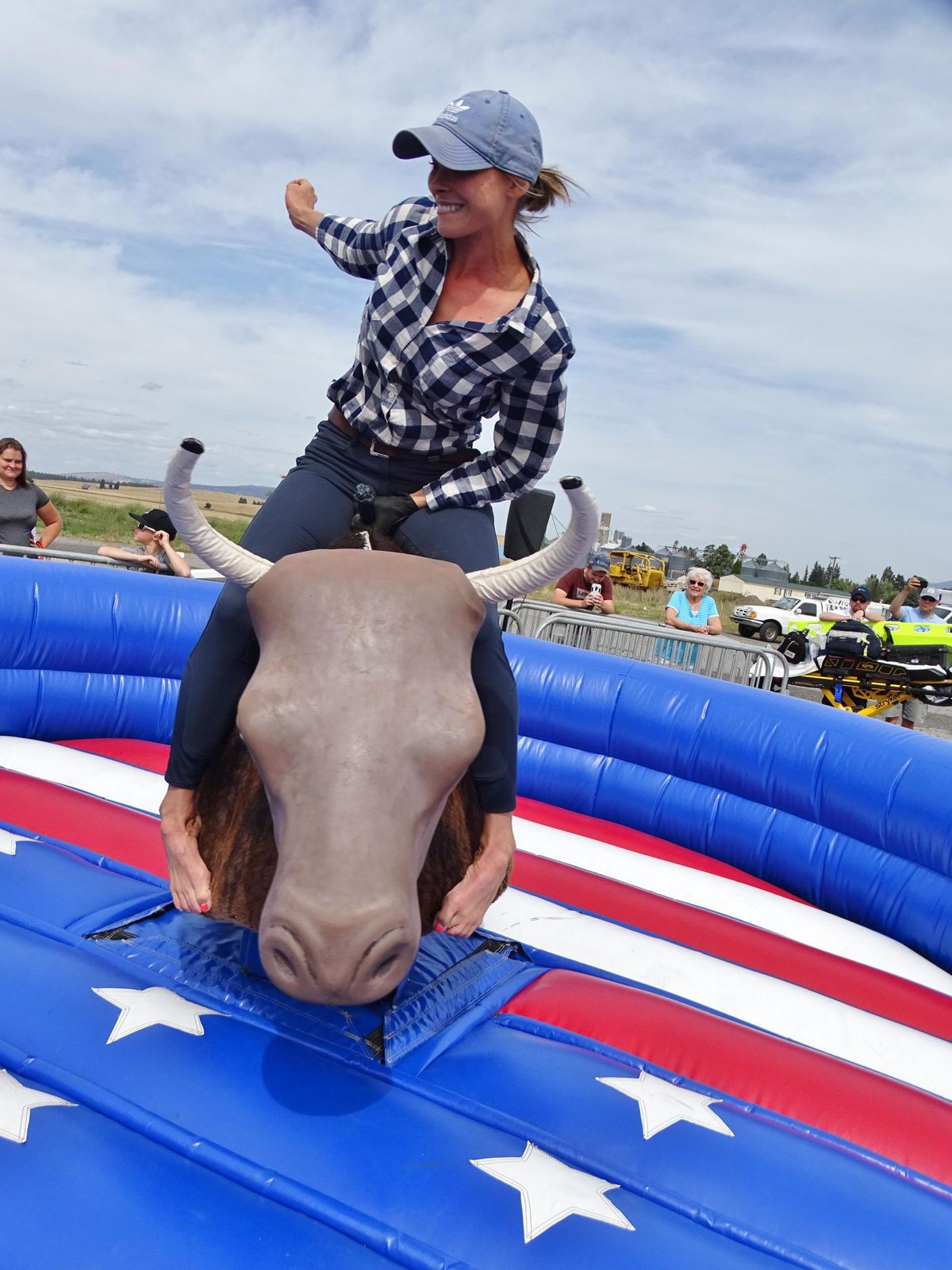Laura Moore, a Washington State University equestrian team coach from Moscow, Idaho, hangs on to capture first place at the mechanical bull “world championship” in Spangle on Saturday, Aug. 24, 2019. (Courtesy, Melaine Williams)
