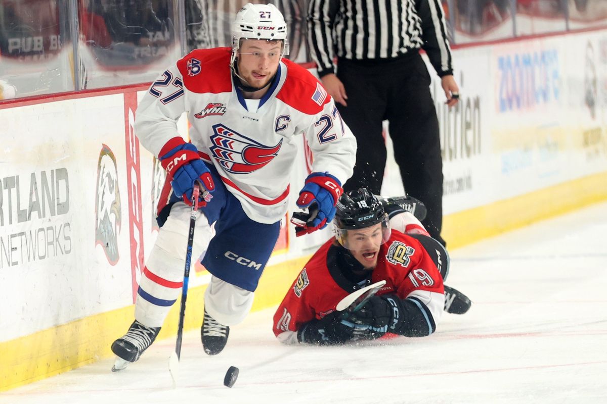 Spokane Chiefs’ Berkly Carlton (27) skates past Portland Winterhawks’ Kyle Chyzowski (19) in game 3 of the Western Conference Championship at the Memorial Coliseum in Portland, Or. (Jaime Valdez)