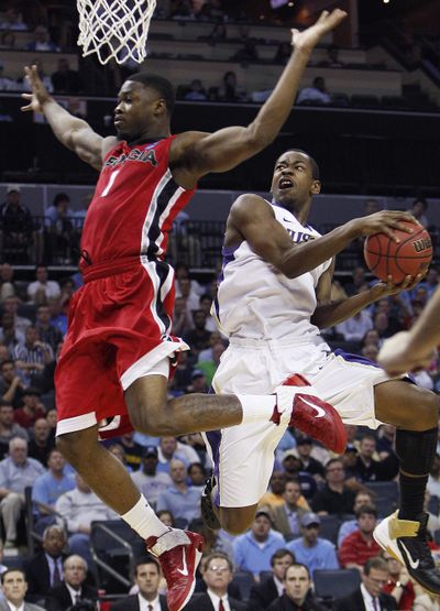 Washington guard Terrence Ross lets Georgia’s Travis Leslie fly by before trying to get to the rim. (Associated Press)