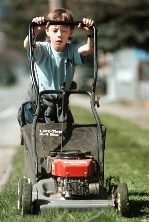 In this SR file photo, a boy helps his grandfather by cutting lawn in the Fort Grounds area of Coeur d'Alene.