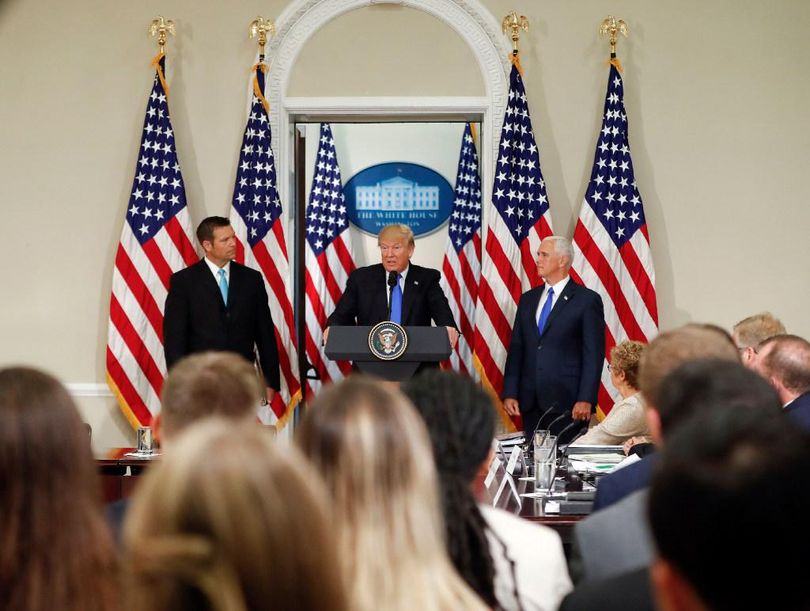 President Donald Trump, with Kansas Secretary of State Kris Kobach, left, and Vice President Mike Pence, right, speaks at a meeting of the Presidential Advisory Commission on Election Integrity, Wednesday, July 19, 2017, in the Eisenhower Executive Office Building on the White House complex in Washington. (Pablo Martinez Monsivais / AP)