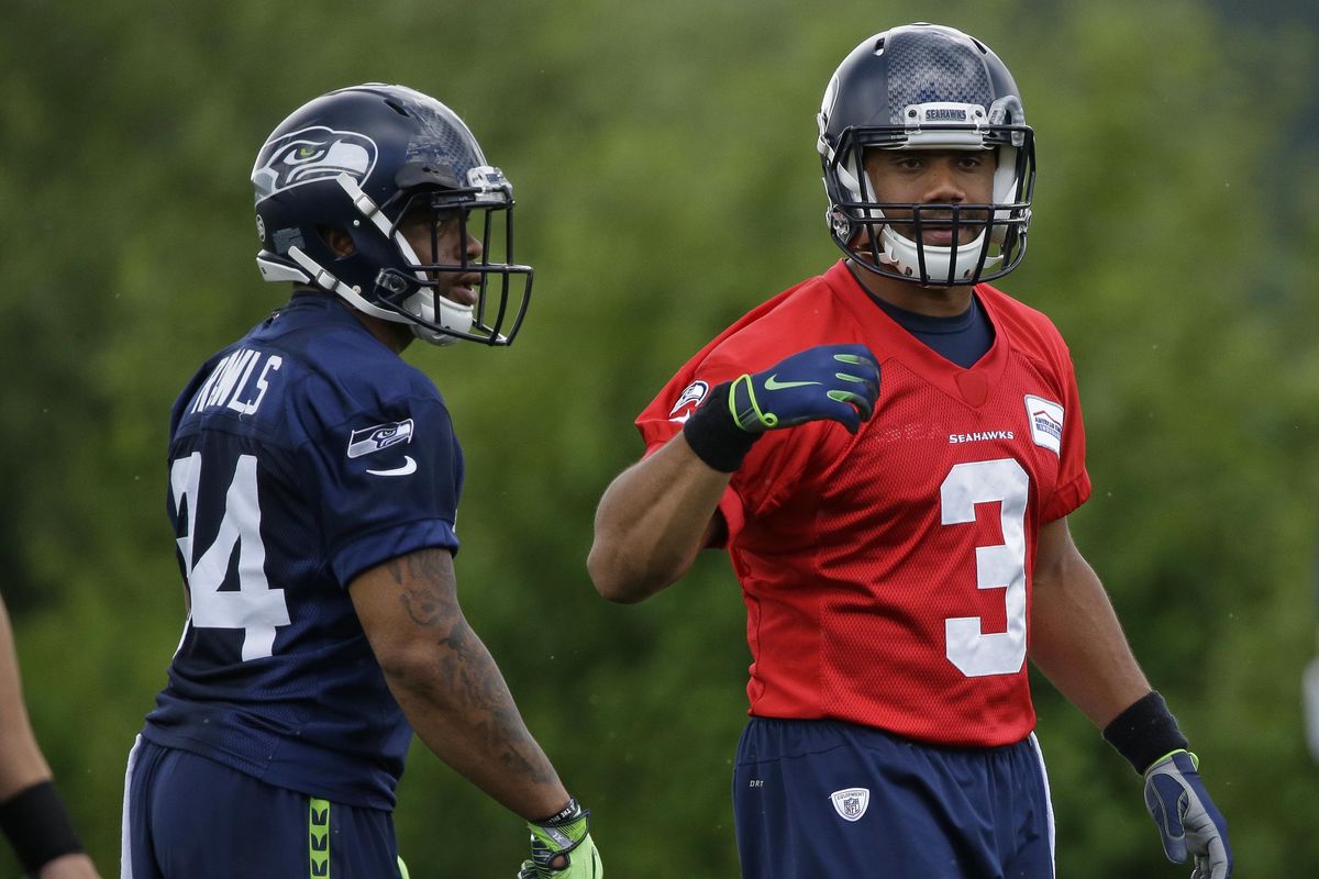 Seattle Seahawks quarterback Russell Wilson (3) stands with running back Thomas Rawls, left, during NFL football practice, Friday, June 9, 2017, in Renton, Wash. (Ted S. Warren / Associated Press)