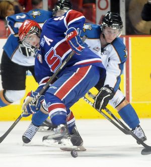 The Spokane Chiefs' Tyler Johnson, left, loses track of the puck for a moment while facing off with Kootenay's Cody Eakin Friday, Jan. 15, 2011 at the Spokane Arena. (Jesse Tinsley / The Spokesman-Review)