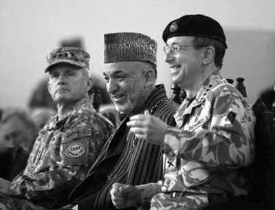 
Afghanistan President Hamid Karzai, center, sits with  British Gen. David Richards, right, and U.S. Gen. Dan McNeill during a change of command in Kabul on Sunday.
 (Associated Press / The Spokesman-Review)
