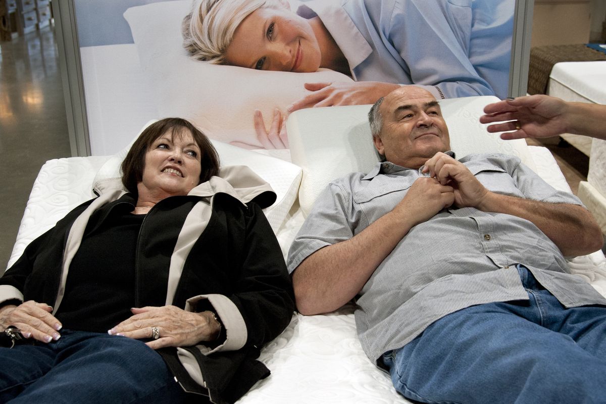 Ann and Spencer Eisenbarth, of Sagle, Idaho, test out mattresses Friday at the SleepCountry USA booth during the Spokane Home and Garden Show at the Spokane Convention Center. (Dan Pelle)