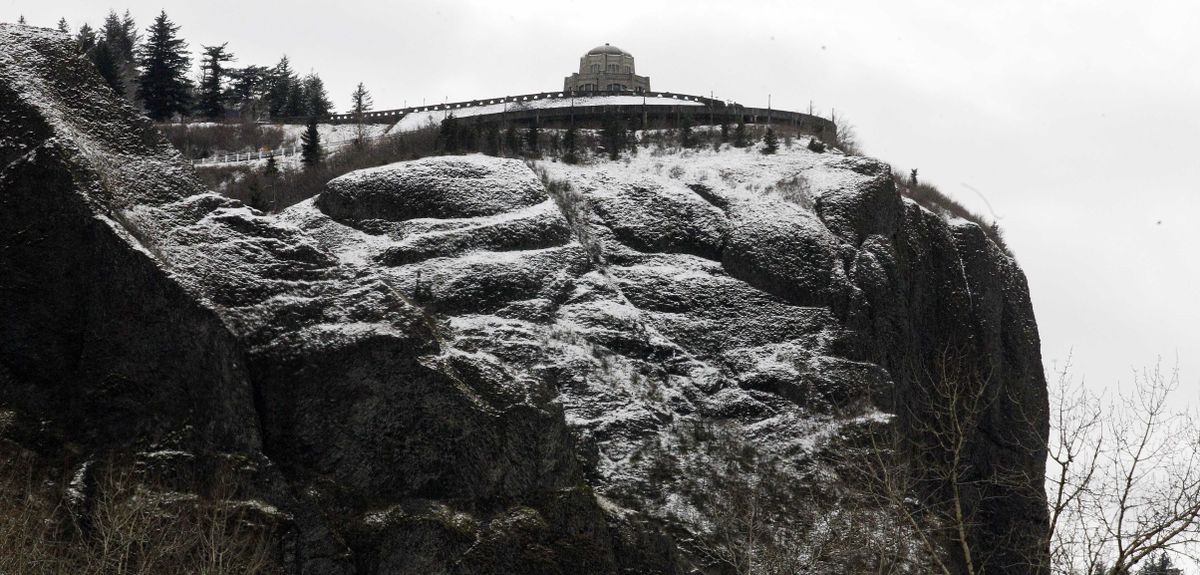 Snow covers the Vista House at the Crown Point State Scenic Corridor along the Columbia River Gorge, near Corbett, Ore., on Monday. Most of Oregon is under some form of winter weather alert through Wednesday afternoon. (Associated Press)