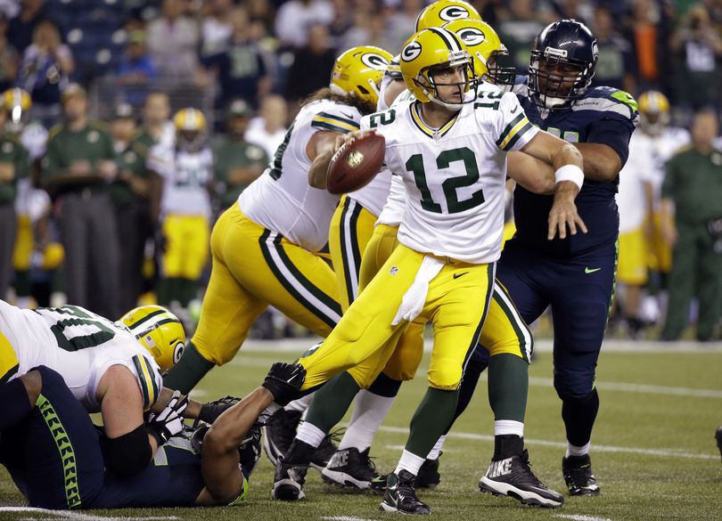 Green Bay quarterback Aaron Rodgers' injured left calf will be tested by a Seattle pass rush that sacked him three times in Week 1. (AP)