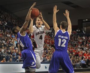 Kevin Pangos of Gonzaga flies between Portland players Tim Douglas, left, and Thomas van der Mars to score during their game at The Kennel Wednesday Dec. 28, 2011. (Christopher Anderson / Spokesman-Review)