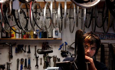 
Tyler Johnson, 20, checks the spokes on a customer's bicycle at Wheelsport on Tuesday. With bike riding season just around the corner, local bicycle shops are preparing for the busy season. 
 (Jed Conklin / The Spokesman-Review)