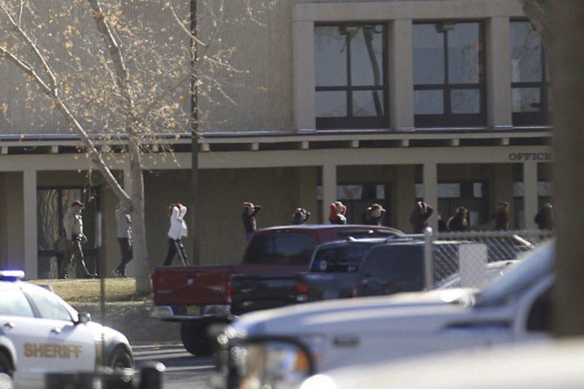 Students are led out of Aztec High School after a shooting Thursday, Dec. 7, 2017, in Aztec, N.M. (Jon Austria / Associated Press)