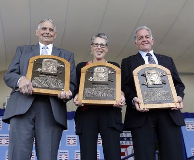 Jerry Watkins, left, great grandson of Deacon White, Anne Vernon, great grandniece of Jacob Ruppert and Dennis McNamara, grandnephew of Hank O’Day, hold plaques. (Associated Press)