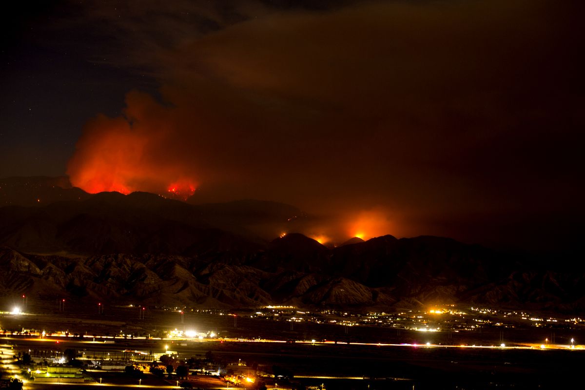 The Apple Fire burns behind mountains near Beaumont, Calif., Sunday, Aug. 2, 2020.  (Ringo H.W. Chiu)