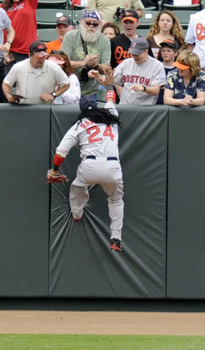 
Manny Ramirez slap hands with a fan after he caught a fly ball in Baltimore. Associated Press
 (Associated Press / The Spokesman-Review)