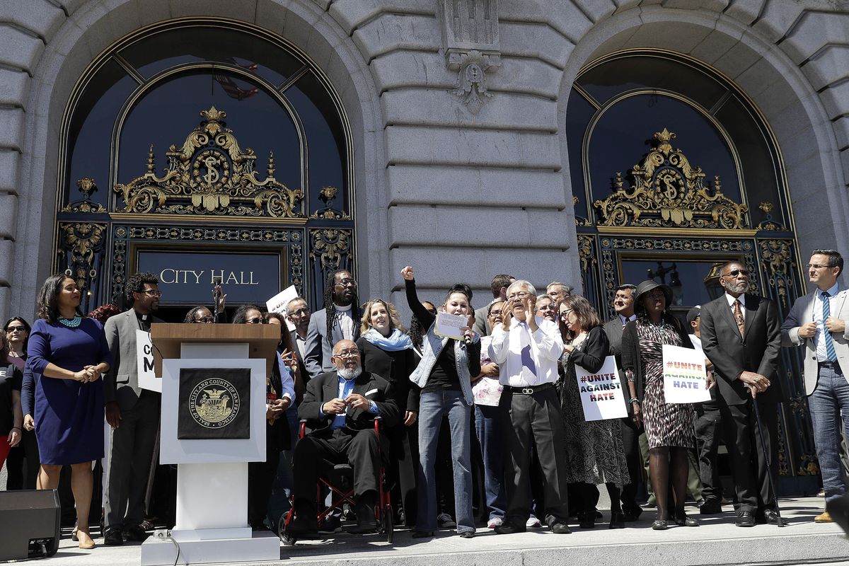 The Rev. Cecil Williams, seated in wheelchair, and Mayor Ed Lee, front row in white shirt, appear at a rally outside City Hall in San Francisco, Friday, Aug. 25, 2017, ahead of politically conservative rallies scheduled this weekend. (Marcio Jose Sanchez / Associated Press)