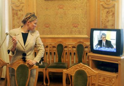 
Ukrainian Prime Minister Yulia Tymoshenko watches Ukraine's President Viktor Yushchenko addressing a press conference on a TV in her office in Kiev Thursday. 
 (Associated Press / The Spokesman-Review)