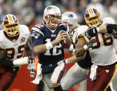 
Patriots quarterback Tom Brady, center, leads a New England team with plenty of records at stake today. Associated Press
 (Associated Press / The Spokesman-Review)