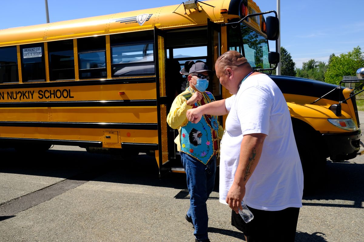 Jason Louie, left, chief of the Lower Kootenay Band of B.C., elbow-bumps Gary Aitken, Jr., chairman of the Kootenai Tribe of Idaho, after Louie arrived stateside during a pop-up clinic Monday at the Porthill Point of Entry north of Bonners Ferry, Idaho.  (Tyler Tjomsland/The Spokesman-Review)