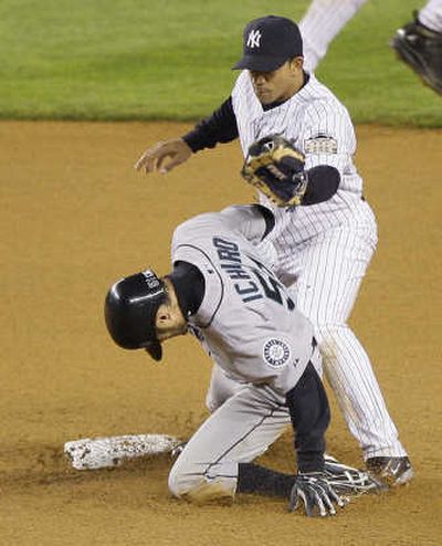 
Ichiro Suzuki slides into second base ahead of the tag from Alberto Gonzalez for one of his three stolen bases Friday night. Associated Press
 (Associated Press / The Spokesman-Review)