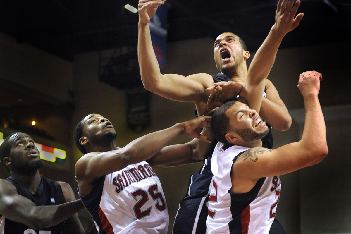 It was physical inside as Gonzaga’s Sam Dower, left, and Elias Harris, above, battle Tim Williams and Rob Jones of Saint Marys for a rebound. (Christopher Anderson)