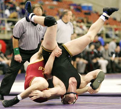 Iowa State's Jon Reader, left, rolls Iowa's Ryan Morningstar, during the 165-pound match in the semifinals of the Division 1 NWCA National Duals wrestling competition in Cedar Falls, Iowa, on Sunday, Jan. 10, 2010. (Rick Tibbott / The Waterloo Courier)