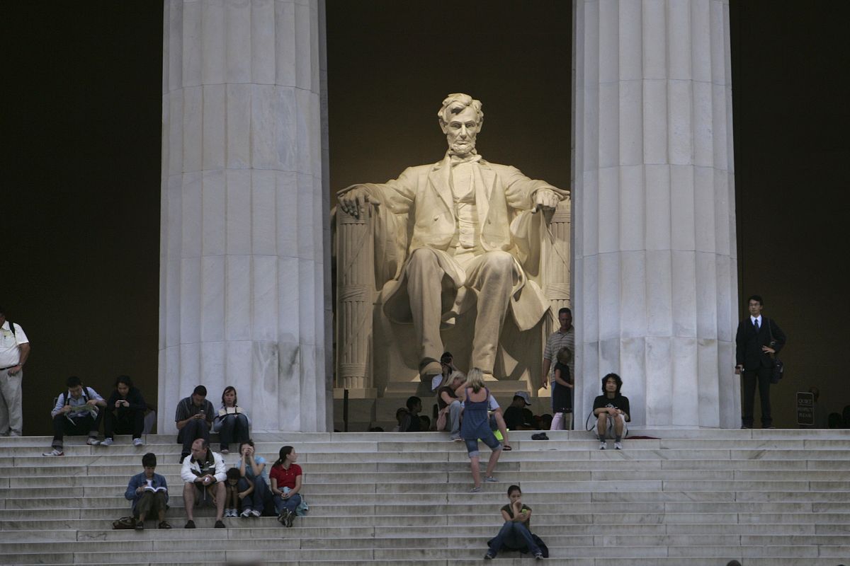 People sit on the steps of the Lincoln Memorial in Washington, D.C. (The Spokesman-Review)