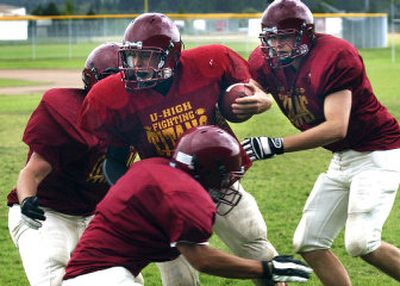 
From left, Clint Moquist, Mike Conrad, Blake Kenworthy (front) and Nate Thompson  run a drill in a University High football practice Monday.
 (Liz Kishimoto/rom / The Spokesman-Review)