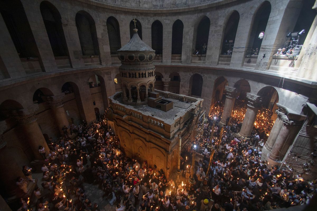 Christian pilgrims hold candles as they gather during the ceremony of the Holy Fire at Church of the Holy Sepulchre, where many Christians believe Jesus was crucified, buried and rose from the dead, in the Old City of Jerusalem, Saturday, May 1, 2021. Hundreds of Christian worshippers took use of Israel