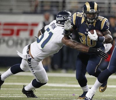 The Rams’ Zac Stacy gave Bruce Irvin (51) and the Seattle Seahawks’ defense fits. (Associated Press)