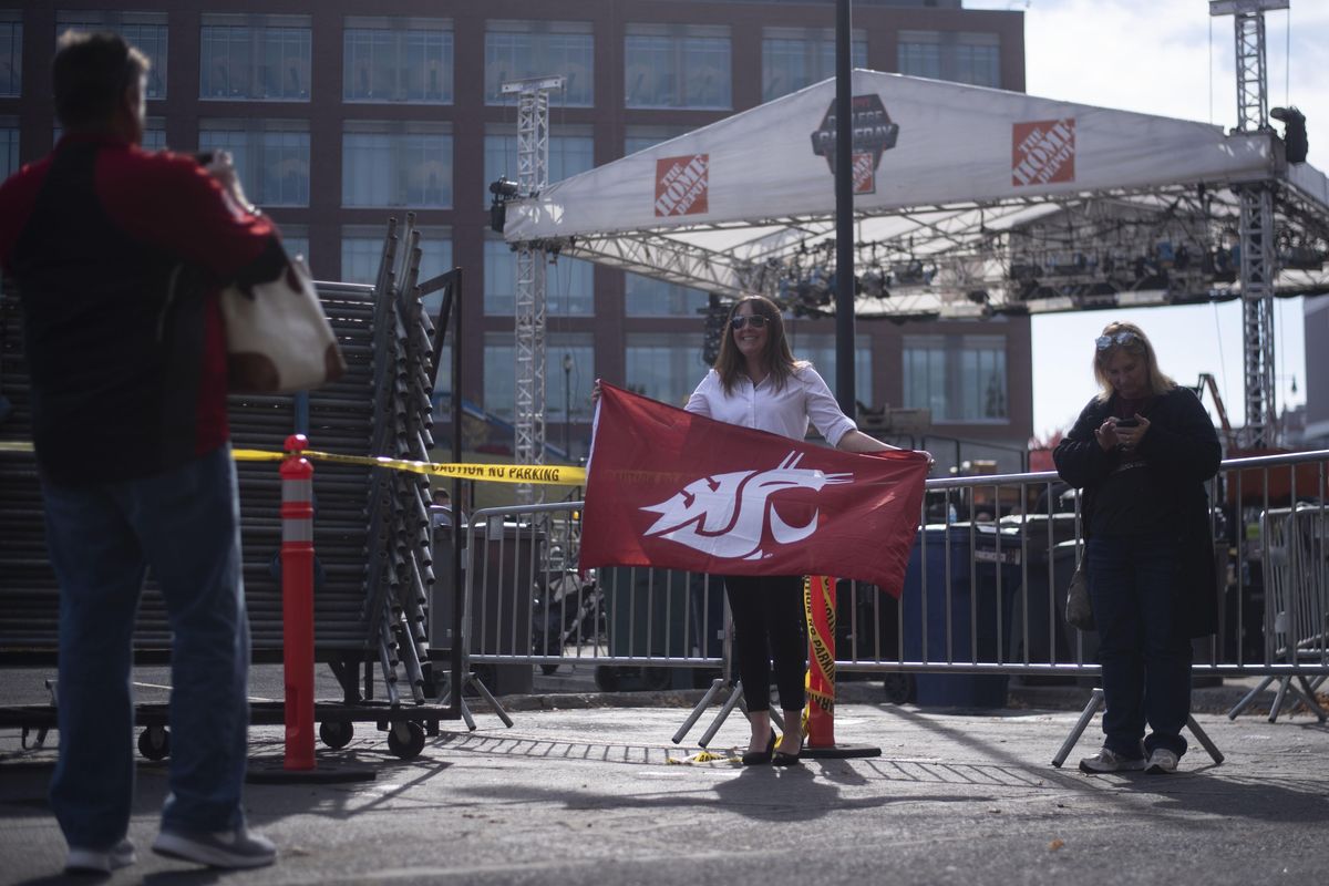 Jessica Riehle poses for a photo in front of the ESPN College GameDay set while it is being constructed, Thursday, Oct. 18, 2018, in Pullman. (Luke Hollister / For The Spokesman-Review)