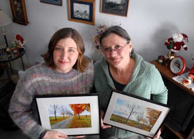 
Photographer Monica Smith, left, holds a photo of an autumn scene, and her mother, Judy Doyle,  holds a watercolor she painted, inspired by Smith's photograph. Doyle has painted several scenes from Smith's photos.
 (Jesse Tinsley / The Spokesman-Review)