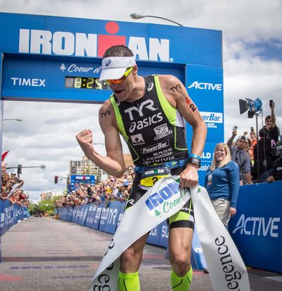 Andy Potts celebrates after crossing the finish line to win the Ironman Coeur d’Alene. (BRUCE TWITCHELL)