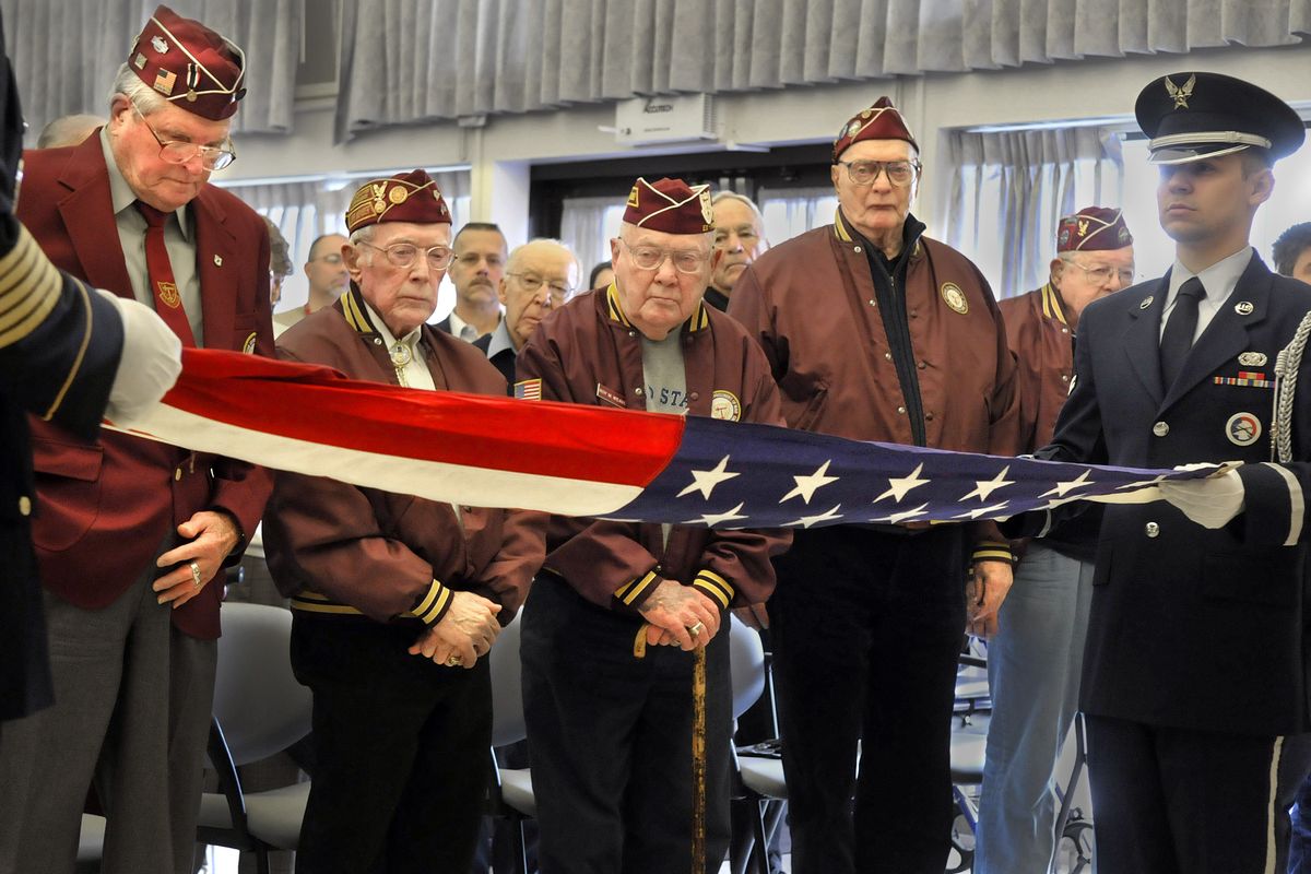 Spokane area POW survivors watch an honor guard perform the ceremony of the 13 folds after listening to Air Force Lt. Col. Dale Storr, who was shot down and taken prisoner during the Iraq war, at the Spokane, Wash. VA Medical Center Friday April 9, 2010 on POW Remenberence Day.  From left are Don Head,  Jack Donahoe, Roy Weaver, Bud Kirchoff and Herman Littman. (Christopher Anderson / The Spokesman-Review)