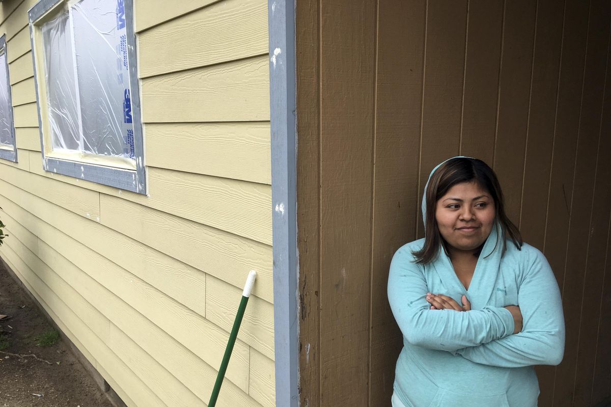In this April 4, 2017, photo, Yesica Sanchez poses for a photo at the Normandy Apartments in Portland, where tenants were notified that their rent was being almost doubled. (Andrew Selsky / Associated Press)