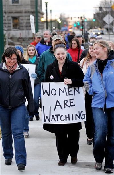 Courtney Bohl of Boise, center, leads people around the State Capitol during silent march against Senate Bill 1387 Monday, March 26, 2012 in Boise, Idaho. (AP Photo/The Idaho Press-Tribune / Adam Eschbach)
