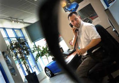 
Sales consultant Jared Wahl, of Downtown Honda, tries to seal a deal over the phone to a prospective owner last week in downtown Spokane.  
 (Brian Plonka / The Spokesman-Review)