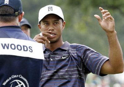 
Tiger Woods, right, talks strategy with caddie Steve Williams on the ninth hole Friday at the Bridgestone Invitational.
 (Associated Press / The Spokesman-Review)