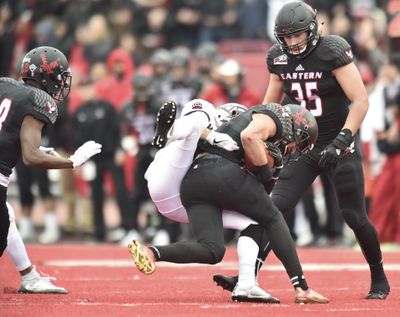 Eastern Washington  defensive back Mitch Fettig  secures an interception against Montana. (Tyler Tjomsland / The Spokesman-Review)