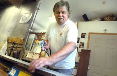 
Terry Shanahan refinishes a table leaf in his workshop. Shanahan specializes in repairing or refurbishing wood furniture.
 (Joe Barrentine / The Spokesman-Review)