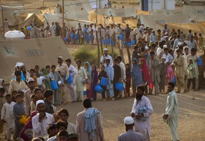 Displaced Pakistanis line up as they wait their turn during a food distribution at Chota Lahore Refugee Camp in Swabi, Pakistan, on Sunday.  (Associated Press / The Spokesman-Review)