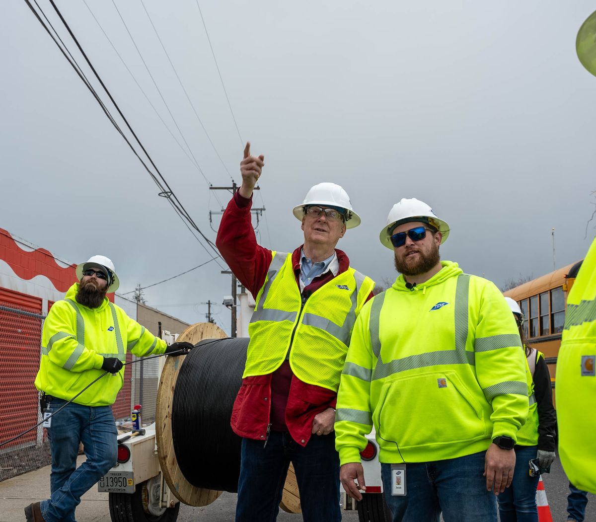 Walter Carlson, President and CEO of TDS Inc. (center), visits a construction site in Spokane where TDS is building an all-fiber, high-speed internet network. (Courtesy TDS)