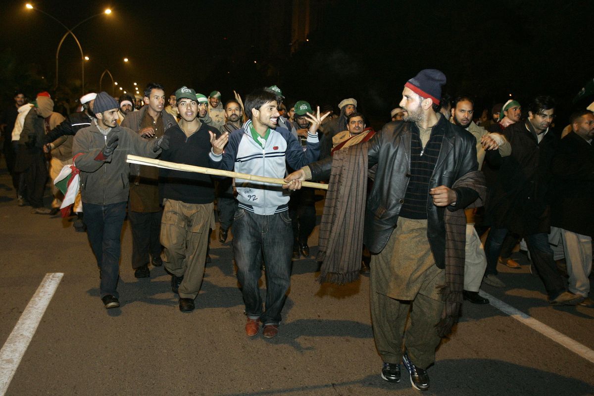 Supporters of Pakistani Sunni Muslim cleric Tahir-ul-Qadri march toward the high-security “Red Zone” at an anti-government rally in Islamabad, Pakistan, today. (Associated Press)