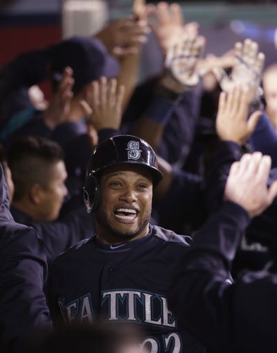 Robinson Cano is congratulated after scoring in third inning. (Associated Press)